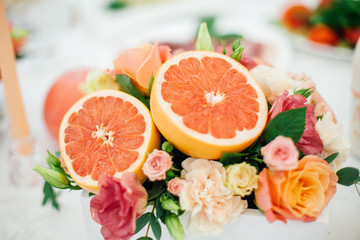 decoration of grapefruit with flowers on the table