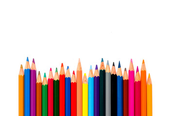 Row of color pencil placed on white background