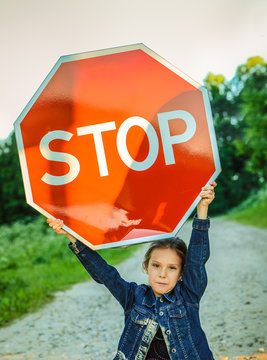 Little Girl Holding A Red Sign 