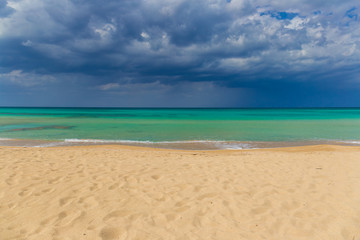 Amazing golden sand beach near Monopolli Capitolo, amazing atmosphere during stormy day, Apulia region, Southern Italy