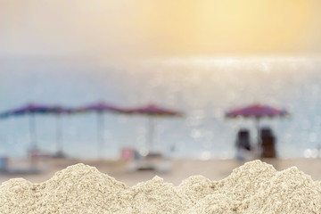 Fototapeta na wymiar Pile of sand on blurred umbrella ,Beach chair on beach for back