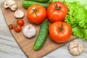 fresh vegetables on a cutting board on a wooden table