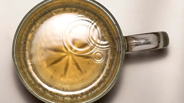 taymlaps soda bubbles in a glass mug top view slow motion
