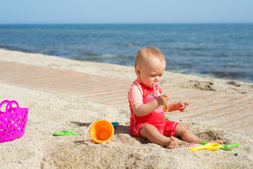 Baby playing at the seaside
