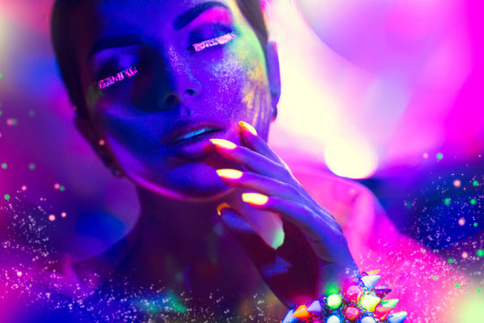 Fashion woman in neon light, portrait of beauty model with fluorescent makeup