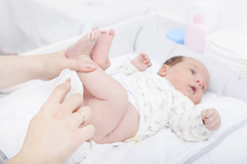 Obraz na płótnie Canvas Changing the diaper of a newborn