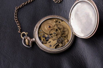 old clock mechanism on black leather background