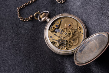 old clock mechanism on black leather background