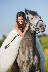 Obraz premium Young happy smiling woman with horse