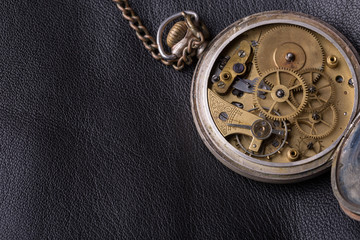 old clock mechanism on black leather background