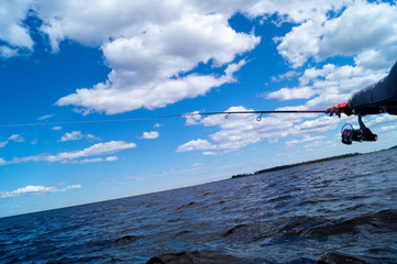 fishing from a boat, Trolling fishing boat rod, sky scenery above the water