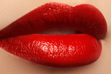 Obraz premium Close-up shot of woman lips with red lipstick. Beautiful perfect lips. Sexy mouth close up. Beautiful wide smile of young fresh woman with full lips