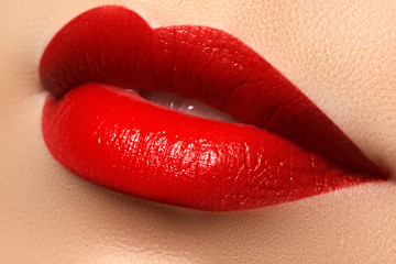 Obraz premium Close-up shot of woman lips with red lipstick. Beautiful perfect lips. Sexy mouth close up. Beautiful wide smile of young fresh woman with full lips