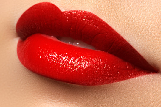 Close-up shot of woman lips with red lipstick. Beautiful perfect lips. Sexy mouth close up. Beautiful wide smile of young fresh woman with full lips


