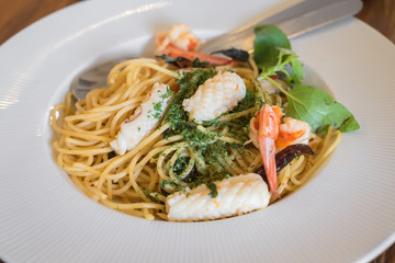 Close up of spicy spaghetti seafood in white dish