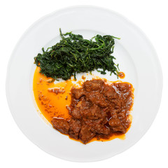 Wild boar stew with hot sauce and spinach, isolated