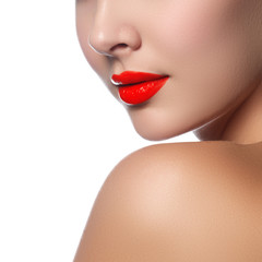 Close-up shot of woman lips with glossy red lipstick. Glamour red lips