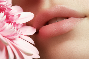 Lips with flower. Close-up beautiful female lips with bright lips