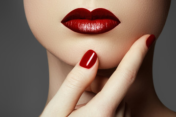 Naklejka premium Red sexy lips and nails closeup. Open mouth. Manicure and make-up