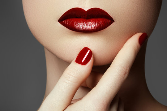 Red sexy lips and nails closeup. Open mouth. Manicure and make-up