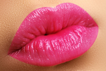 Obraz premium Perfect smile. Beautiful full pink lips. Pink lipstick. Gloss lips