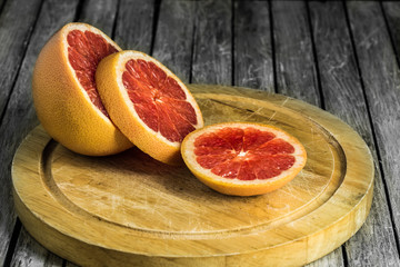cut grapefruit on a wooden Board