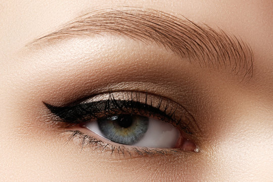 Cosmetics & make-up. Beautiful female eye with sexy black liner
