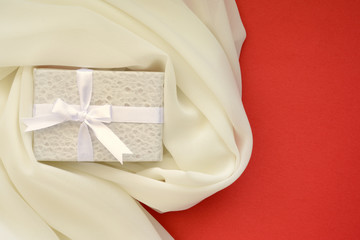 ギフトボックスと白色の布　赤色背景
