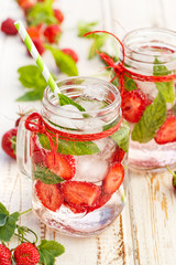 Flavored water with addition of fresh strawberries and mint