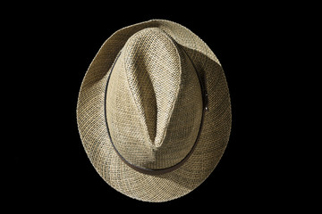 Casual straw hat on black background