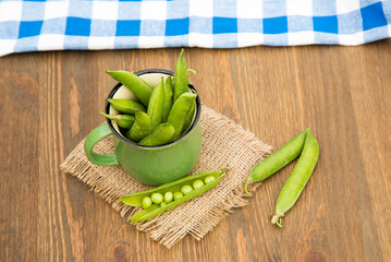 Green pea in bowl  on rustic wooden background