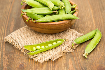Green pea in bowl  on rustic wooden background