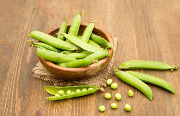 Green pea in bowl  on rustic wooden background