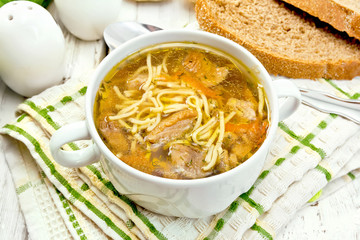 Soup with mushrooms and noodles in bowl on napkin