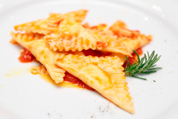 Ravioli with tomato sauce and herbs