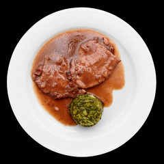 Stewed meat in plate isolated on black