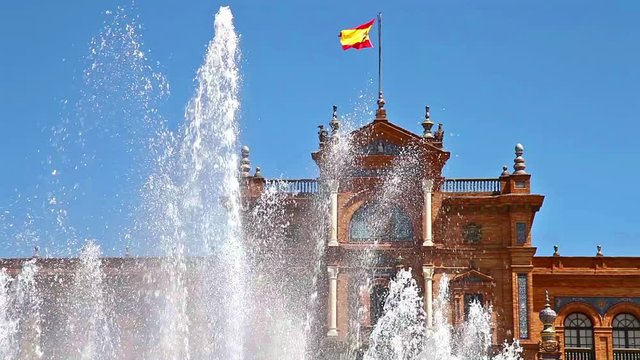 close up of the fountain at Plaza de Espana square in Seville city with main building and spanish flag, Andalusia, Spain
