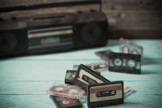 old cassette tape and player on the wood background