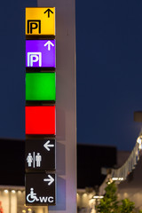 directional signs on a pole shopping center
