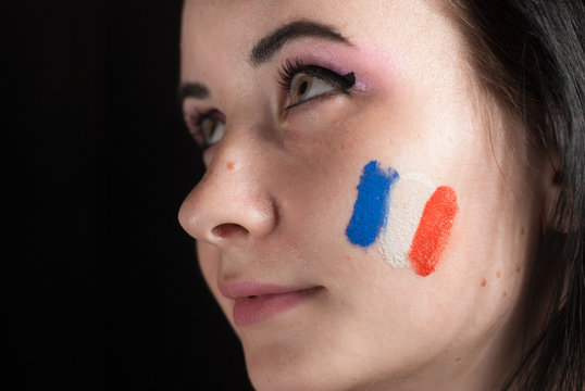 Painted woman face with flag of France