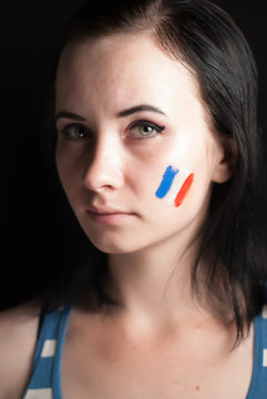 Painted woman face with flag of France