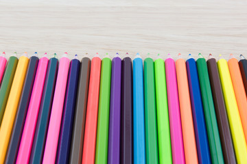 Fototapeta premium Colors pencils, colorful many crayons on wood background