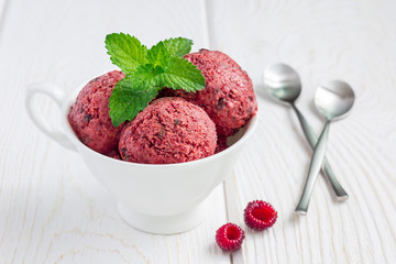 Homemade raspberry, yogurt, chocolate chips ice cream balls, horizontal