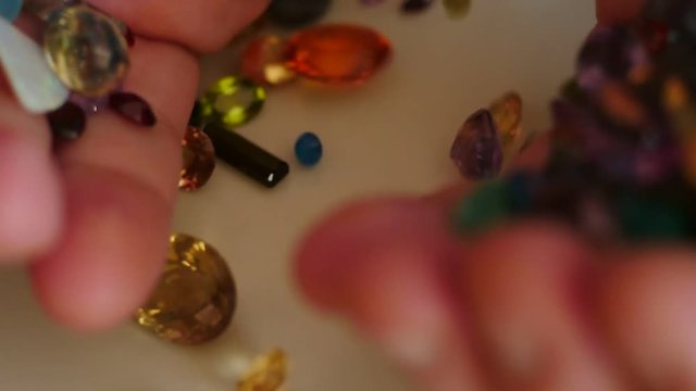mail hand pour out precious gemstones slow motion