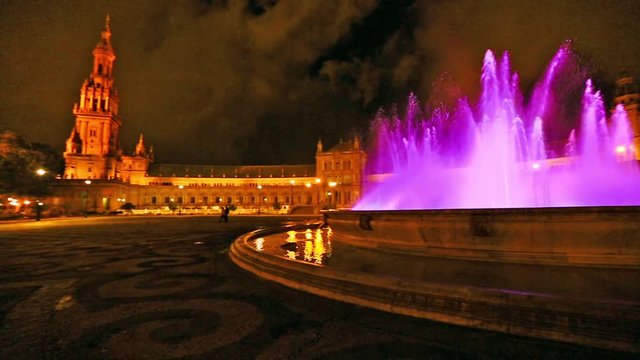 180 degree panoramic view of the pink fountain at Plaza de Espana square in Seville city by night, Andalusia, Spain