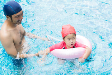 Family in pool of baby and father