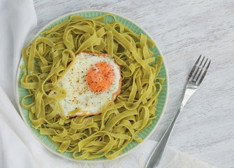 Green pasta with fried egg