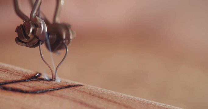 Artist using pyrography to decorate a buddhist prayer wheel