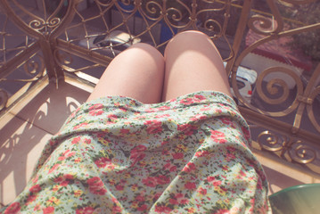 Legs of a young woman on a sunny day. Filtered image in faded, washed out, retro style, summer vintage concept. Personal perspective.