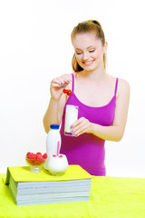beautiful young girl drinking yogurt , milk and fruit
